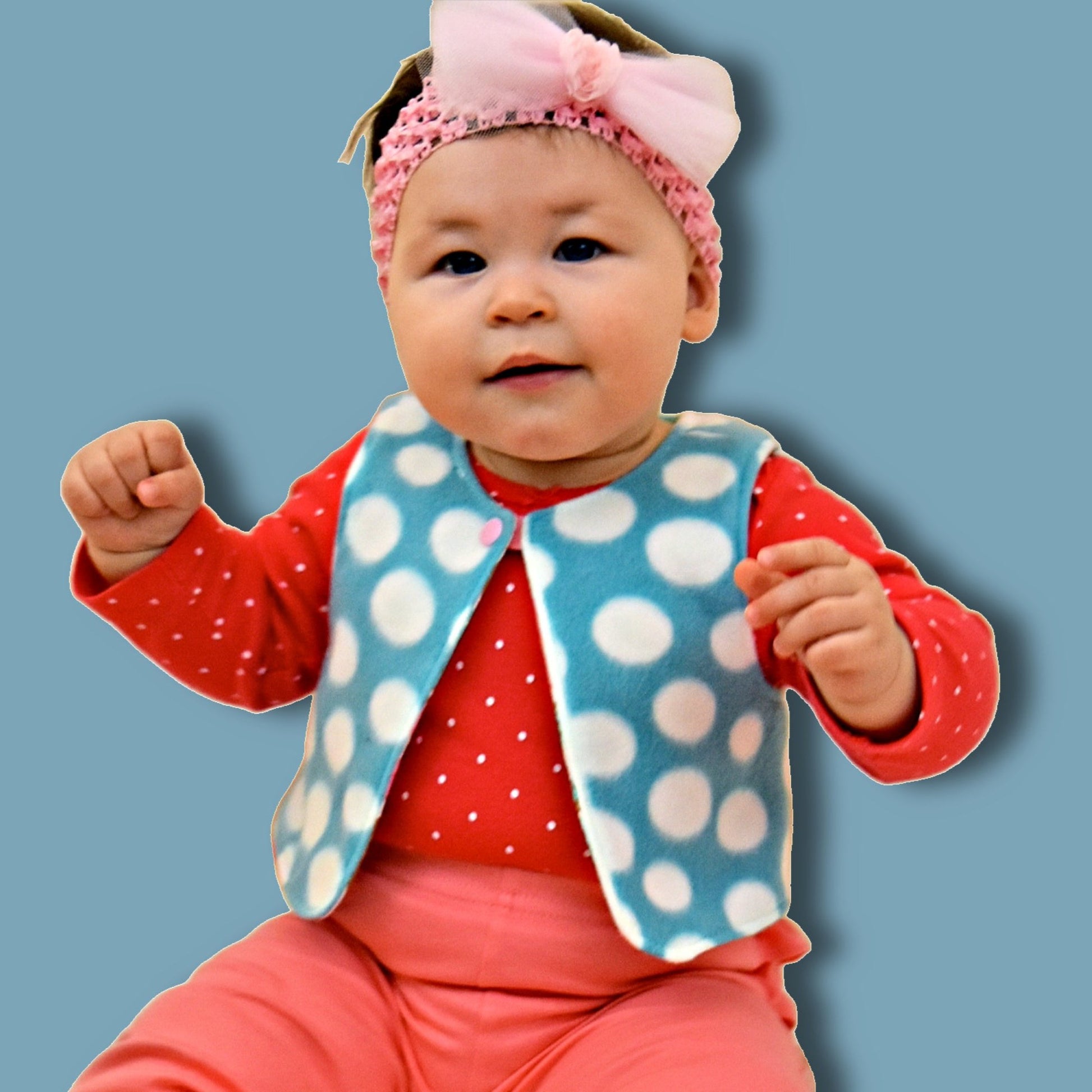 Baby vest, pdf sewing pattern, age 1-12. Fully reversible with cute KamSnap closure. In warm blue and white polka dot fleece and brushed cotton lining with large donut print.