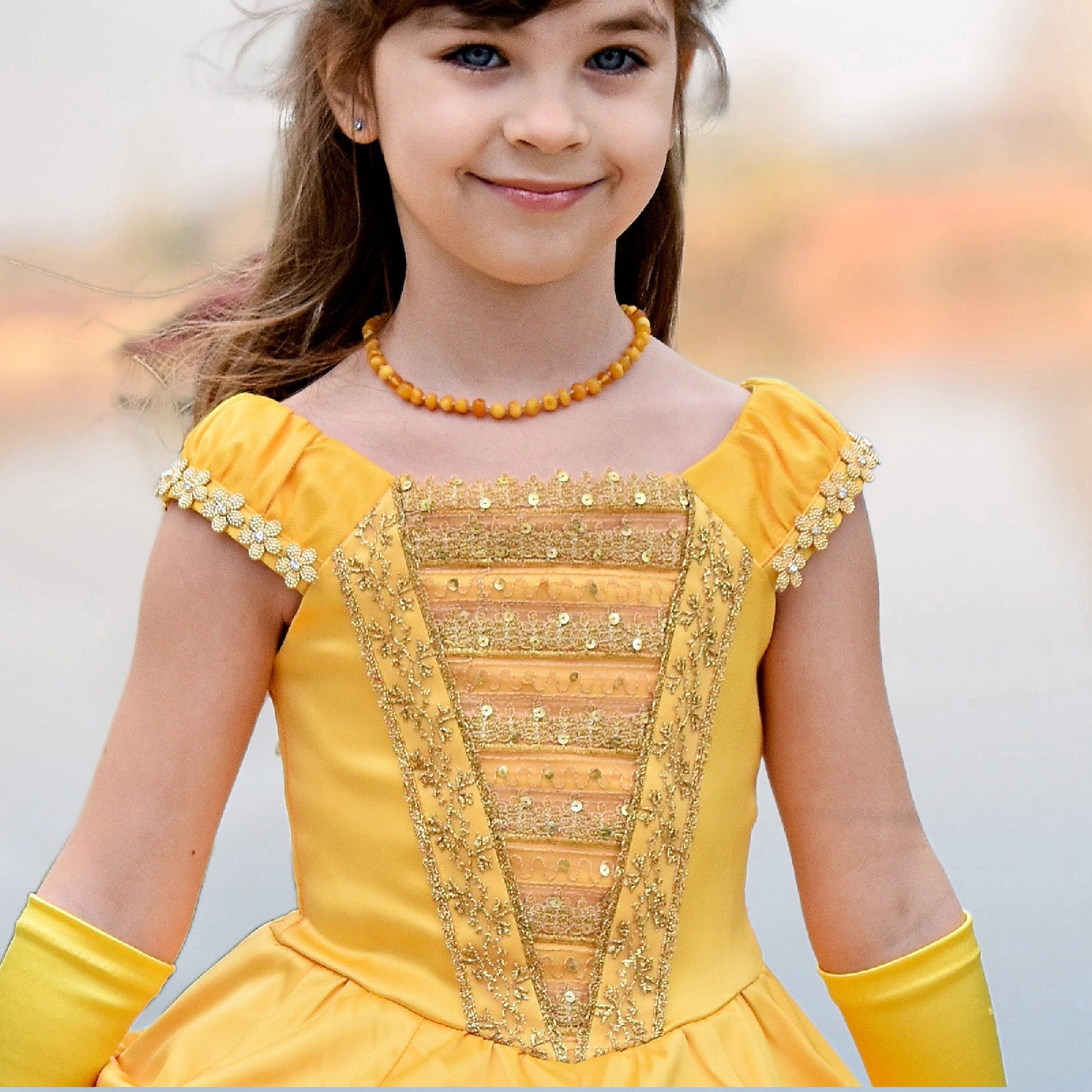 Belle costume, pdf sewing pattern by Frocks & Frolics. With classicrushed up skirt layers and panels. Gathered sleeve with embroidery and center front bodice. In gold duchess satin.