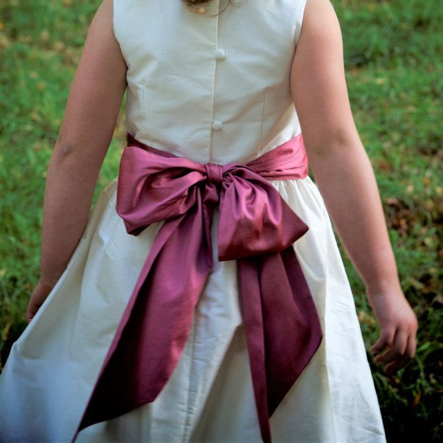 Flower girl dress pdf sewing pattern, cummerbund sash, big bow, classic flower girl frock, pink sash, cream bodice, covered buttons, rouleaux loop fastening. Free You Tube Video playlist. View of cummerbund and pearl embroidery.