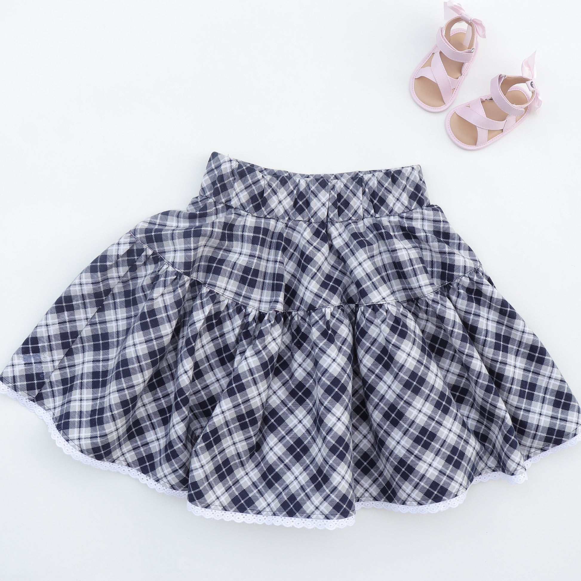 Bonnie twirl skirt with yoke and a gathered circle skirt. With gorgeous lace trim and generous back ties, pdf sewing pattern by frocks and frolics.