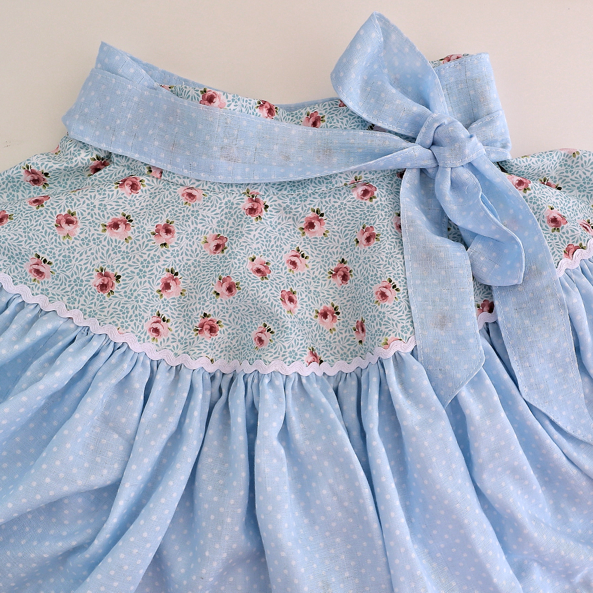 Bonnie twirl skirt with yoke and a gathered circle skirt. With gorgeous lace trim and generous back ties, pdf sewing pattern by frocks and frolics.