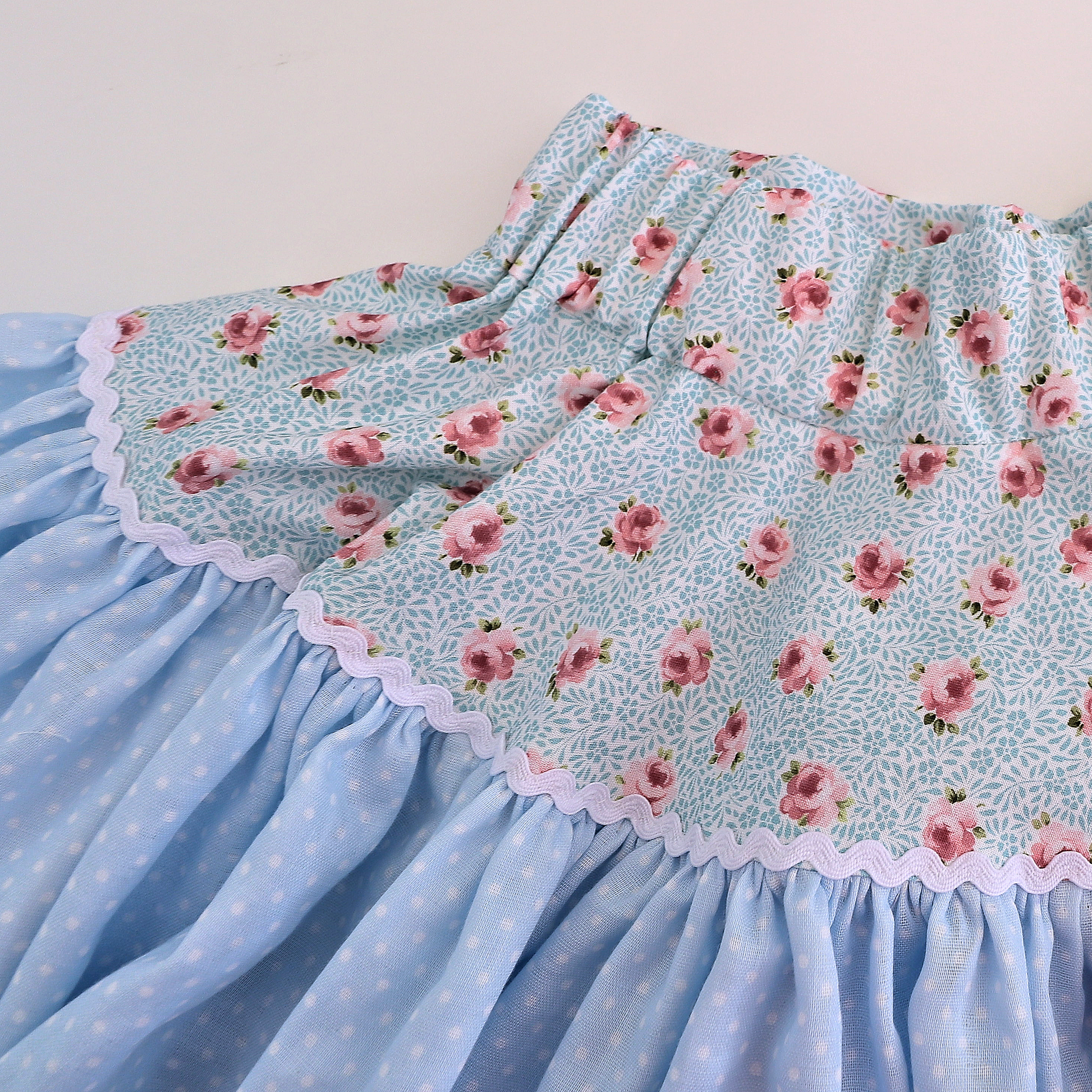 Bonnie twirl skirt with yoke and a gathered circle skirt. With gorgeous lace trim and generous back ties, pdf sewing pattern by frocks and frolics.