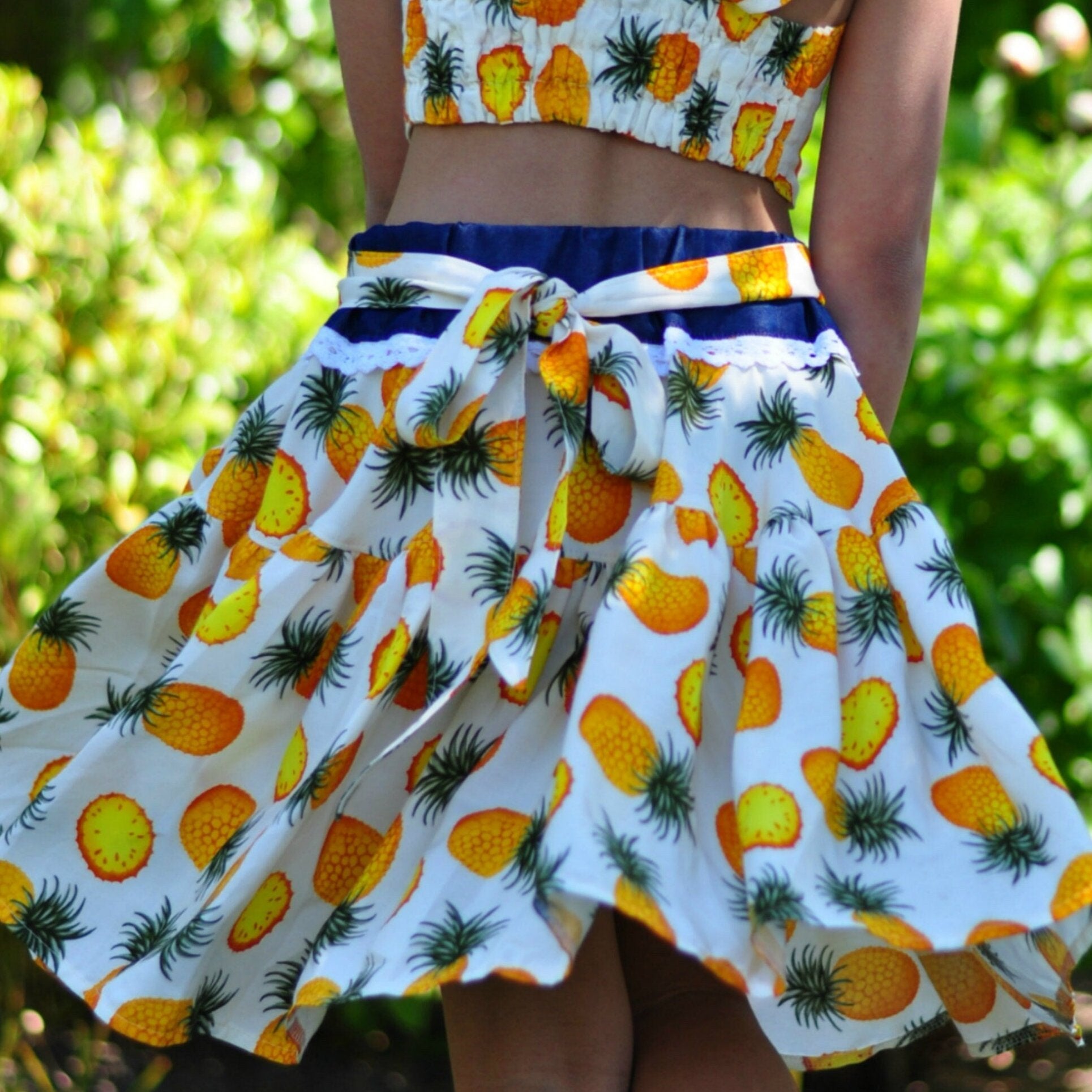 Bonnie twirl skirt with yoke and a gathered circle skirt. With gorgeous lace trim and generous back ties, pdf sewing pattern by frocks and frolics.