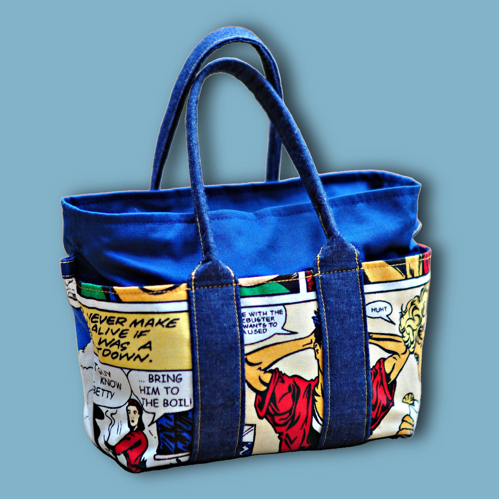 Mini tote bag in blue denim with Marvel contrast fabric for this kids bag pattern. Frontal view.
