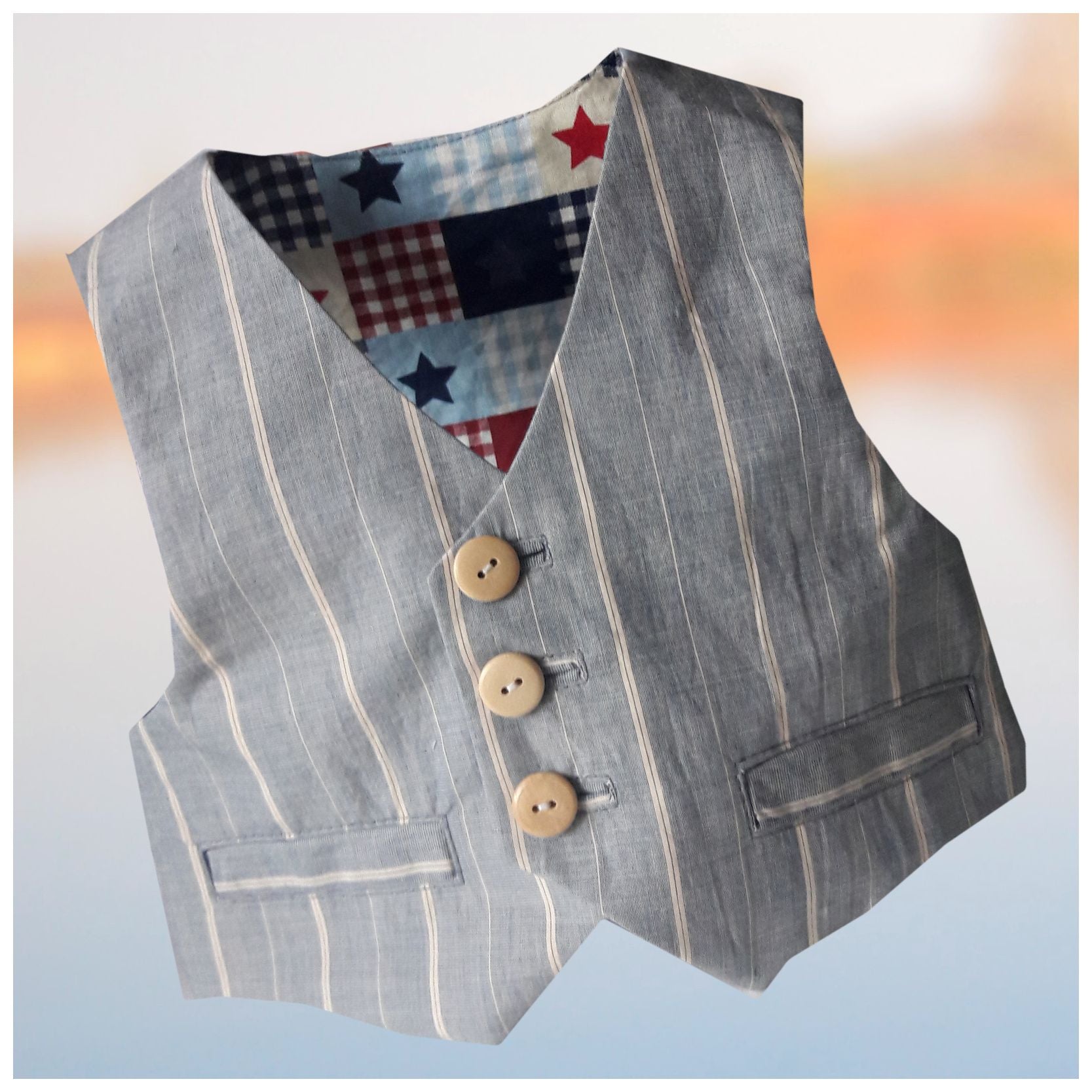 Brooklyn waistcoat, pdf sewing pattern by frocks and frolics. Fully lined with tie backs. Front view of waistcoat, striped with welt pockets and wooden buttons. Includes a free video sewing course.