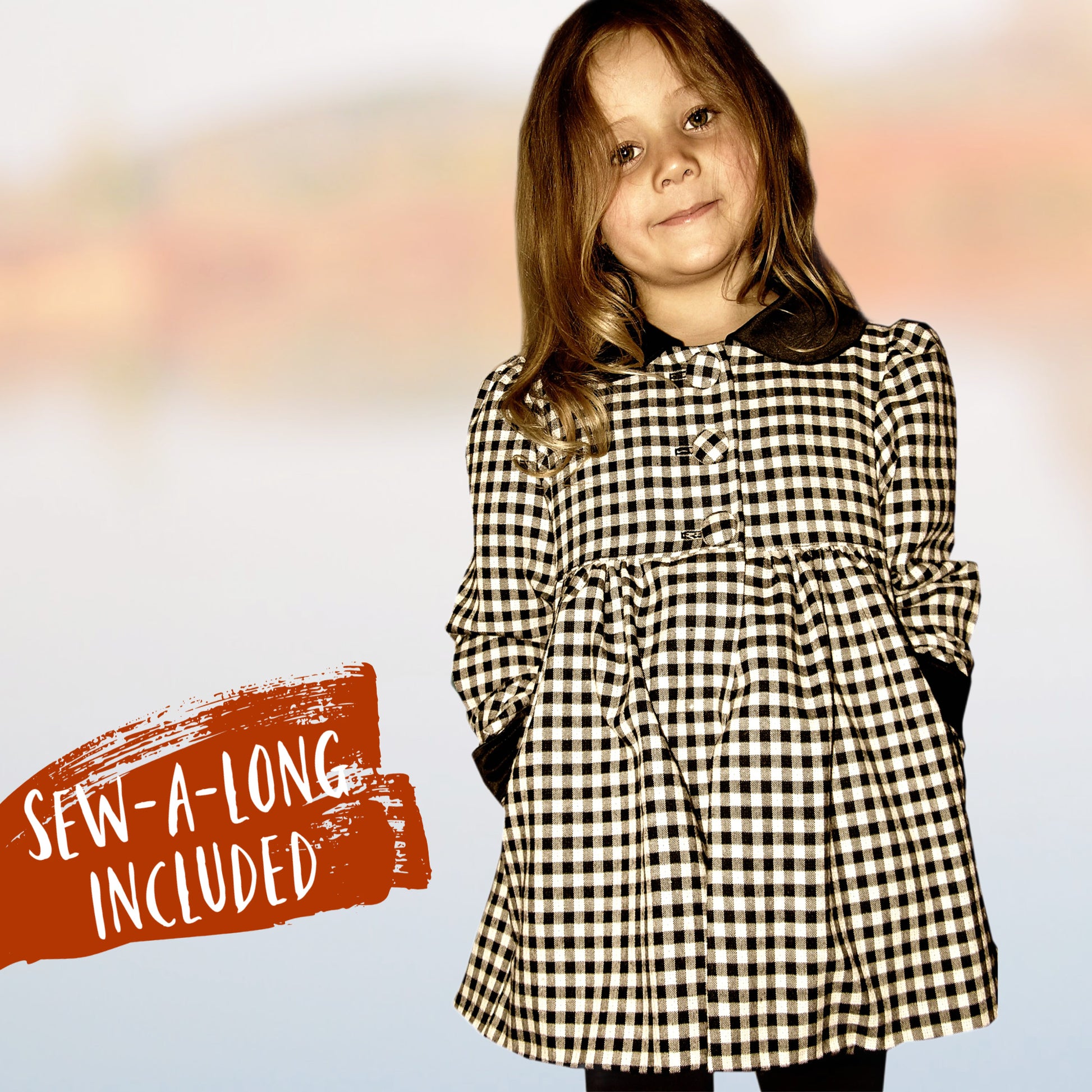 Charlotte girls coat, pdf sewing pattern by Frocks & Frolics. In black and white gingham with black collar and cuffs. Long puff sleeves with cuffs and tabs. Featuring a yoke and rounded collar. Back view of the tab and buttons. Includes video tutorials.