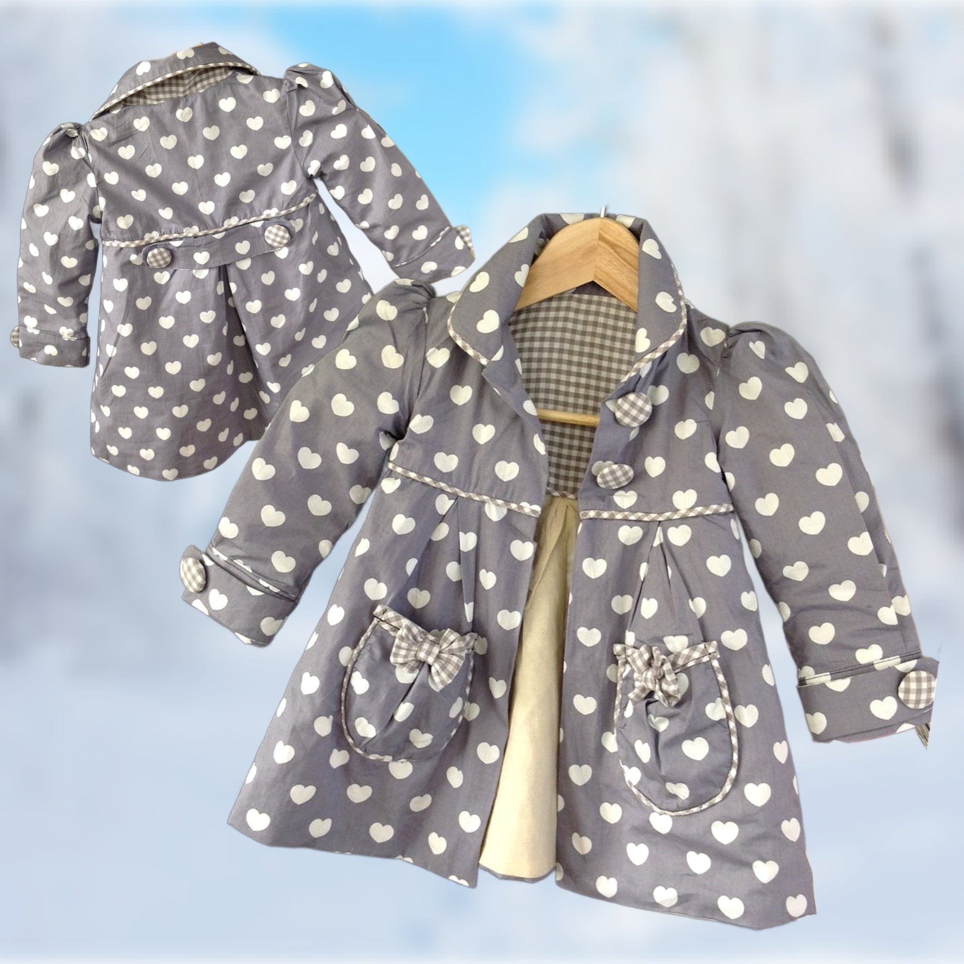 Charlotte girls coat, pdf sewing pattern by Frocks & Frolics. In heart shaped white polka dots on grey cotton with gingham lining.. Long puff sleeves with cuffs and tabs. Featuring a yoke and rounded collar.