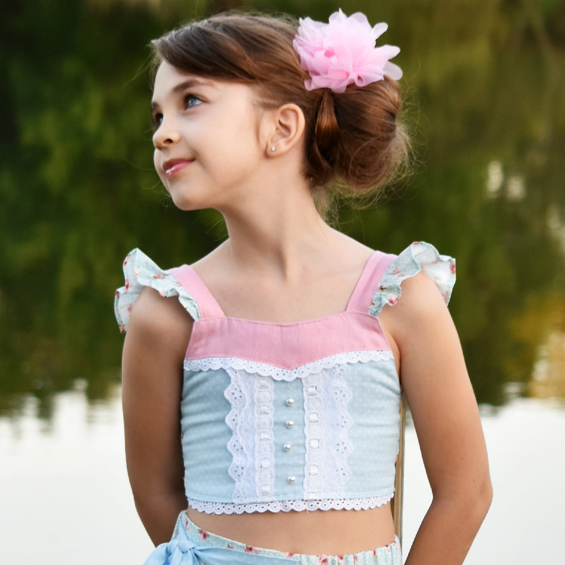 Connie blouse, pdf sewing pattern by Frocks & Frolics. Featuring a decorative yoke in pink linen with lace edging. Cute flutter sleeves in pastel blue and pink print by Michael Miller. Front bodice lace embroidery and pearl buttons complete the look.