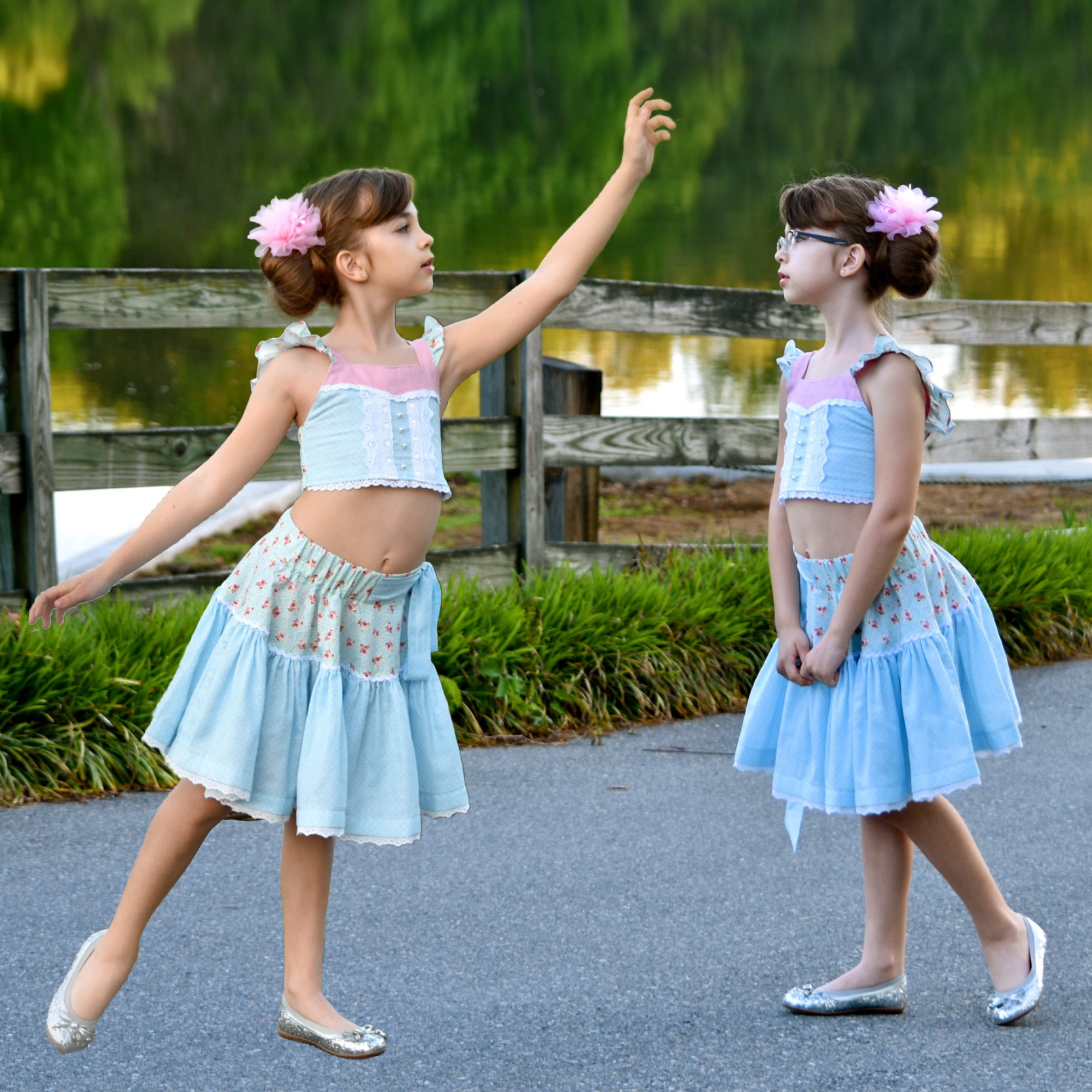 Connie blouse, pdf sewing pattern by Frocks & Frolics. Featuring a decorative yoke in pink linen with lace edging. Cute flutter sleeves in pastel blue and pink print by Michael Miller. Front bodice lace embroidery and pearl buttons complete the look.