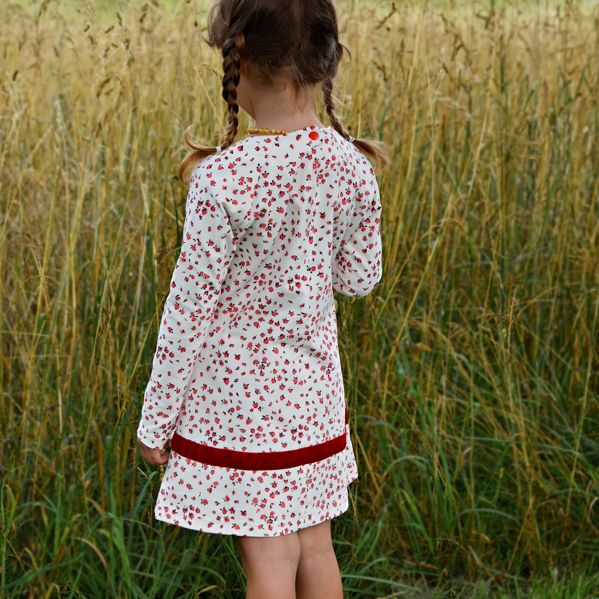 Daisy dress, pdf sewing pattern. Jersey dress with long raglan sleeves and faux turn up. The dress has a KamSnap back closure and deep decorative hem trim. The pattern comes with a step-by-step video tutorial.