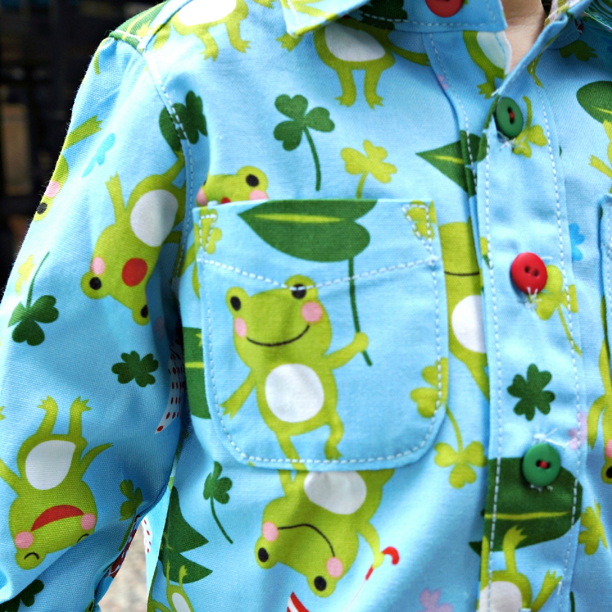 Cool shirt, pdf sewing pattern for a button down shirt by Frocks & Frolics.  The shirt has a cute frog print by Michael Miller fabrics. The pattern comes with a video guide for every step.