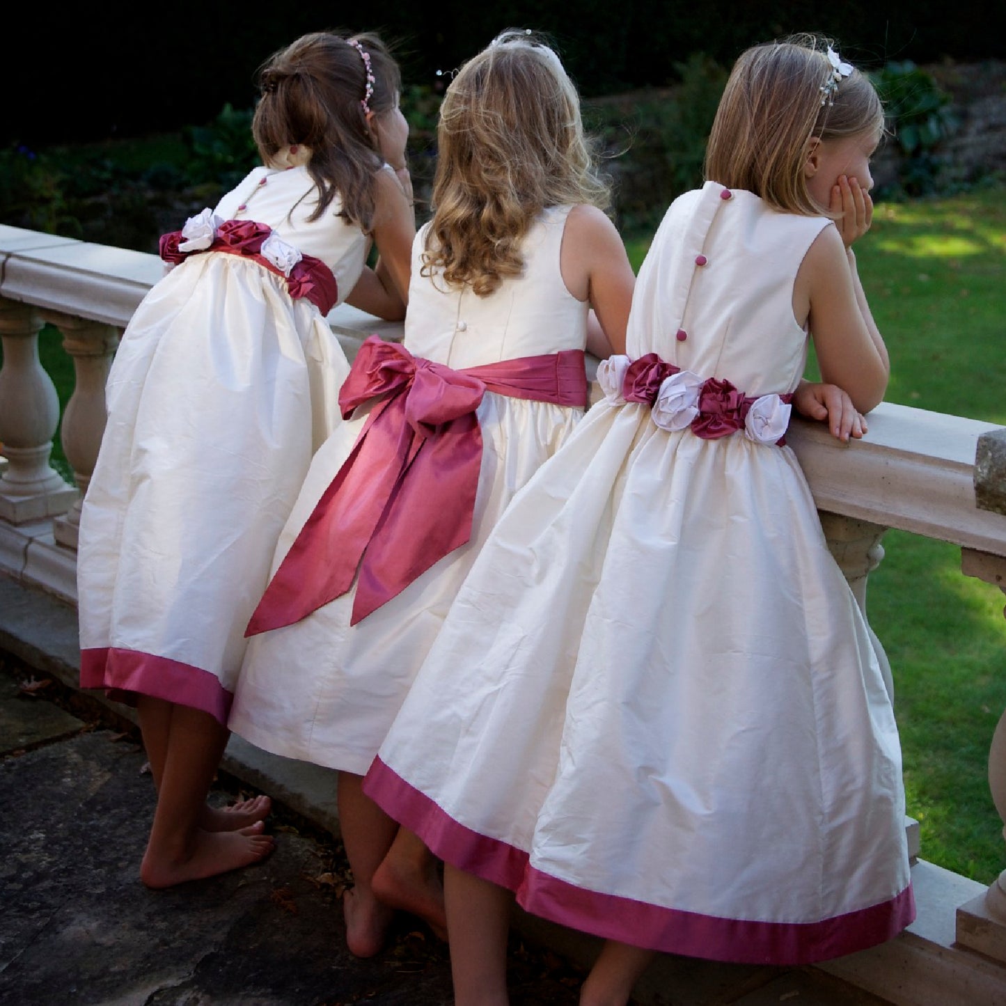 Flower girl dress pdf sewing pattern, cummerbund sash, big bow, classic flower girl frock, pink sash, cream bodice, covered buttons, rouleaux loop fastening. Free You Tube Video playlist. Back view of the handcovered cover buttons, bows and roses.