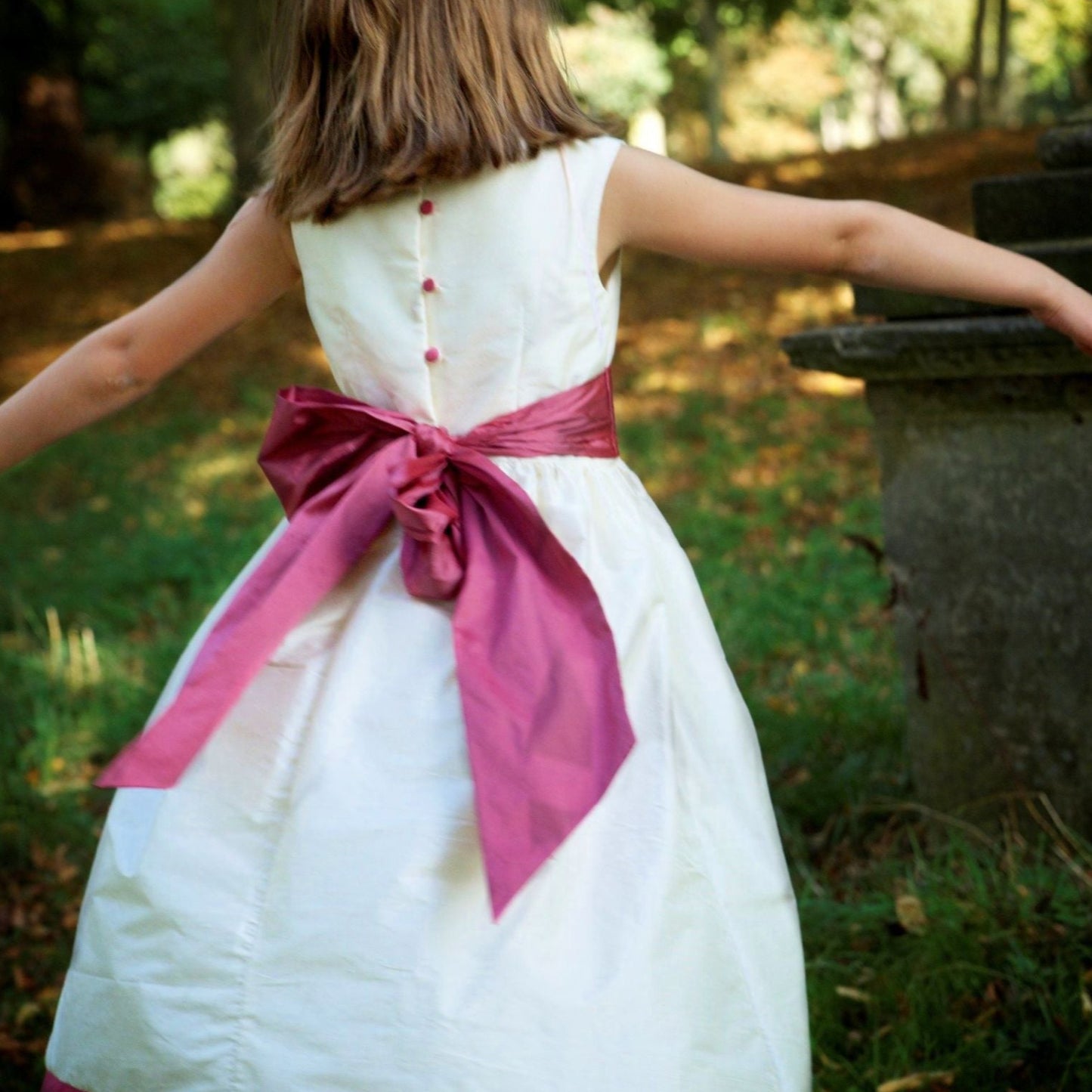 Flower girl dress pdf sewing pattern, cummerbund sash, big bow, classic flower girl frock, pink sash, cream bodice, covered buttons, rouleaux loop fastening. Free You Tube Video playlist.
