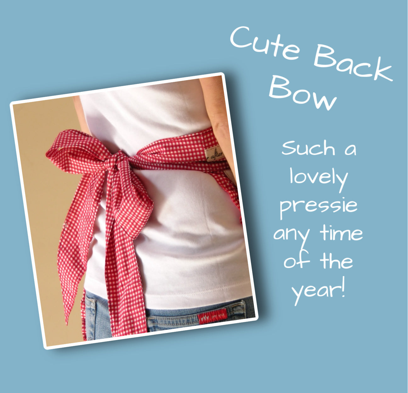 Christmas apron with snowman applique. Pdf sewing pattern by Frocks & Frolics. Fully lined, cute tie backs, free video sew-a-long. In gingham white and blue cotton with red trim bias binding and pockets.