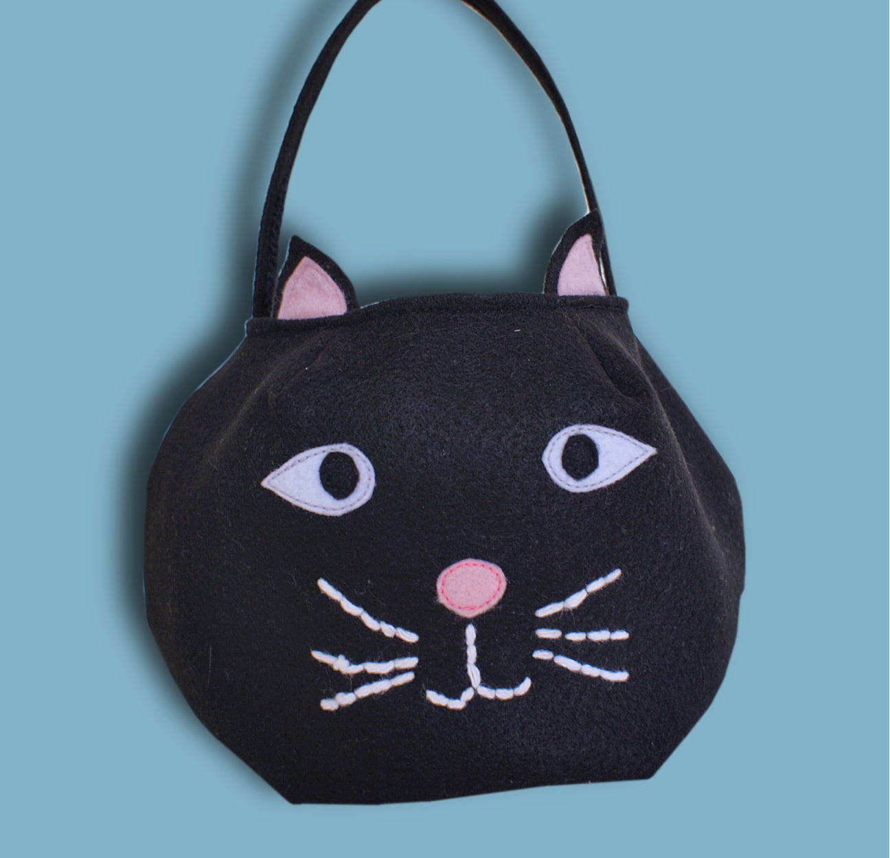 Halloween treat or trick basket, pdf sewing pattern by Frocks & Frolics. Black felt bag with cat applique.