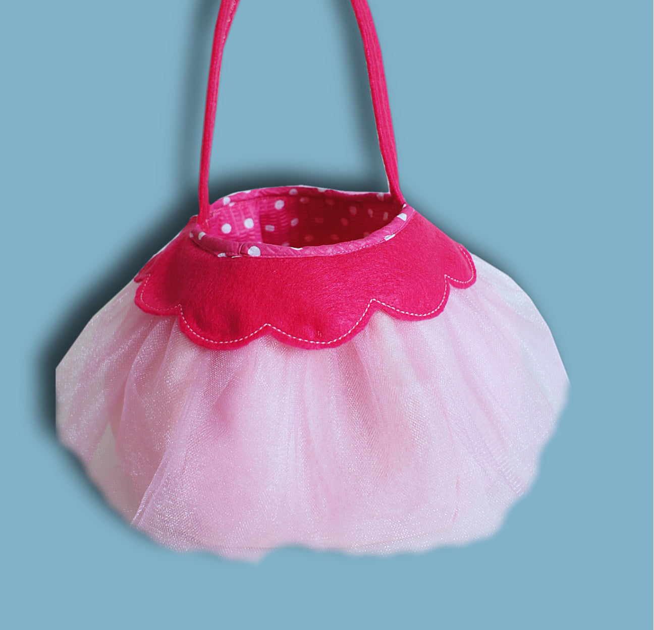 Halloween treat or trick basket, pdf sewing pattern by Frocks & Frolics. Princess basket with a pink scalloped rim and polka dot lining. Lots of tulle arount the outside too.