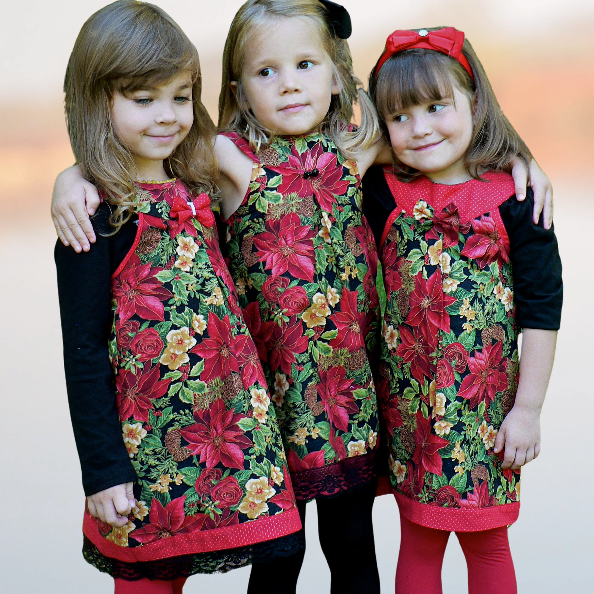 Pretty girl wearing a cute blouse with round yoke collar. Its in a Michael Miller Gingham and has decorative roses attached to the round yoke. The side view reveals a fully lined armhole. The hem has a slim lace trim.