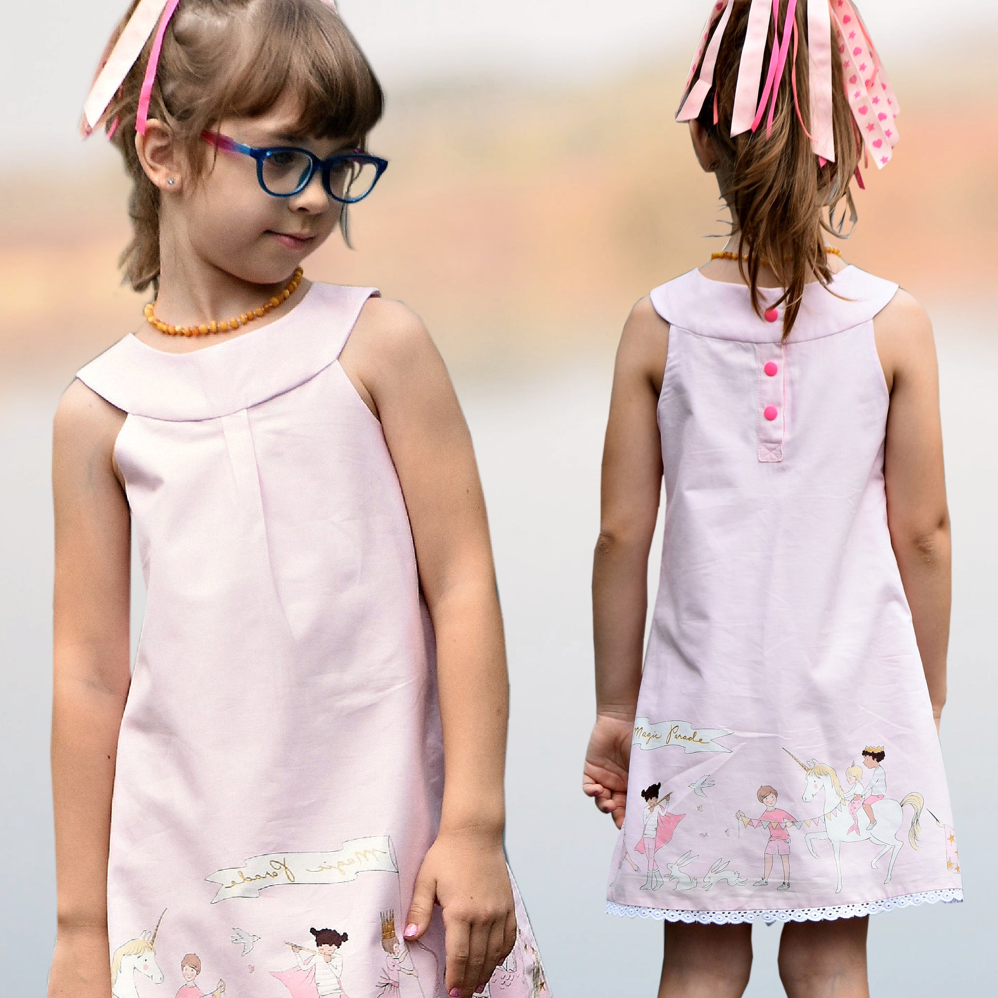 Pretty girl wearing a cute blouse with round yoke collar. Its in a Michael Miller Gingham and has decorative roses attached to the round yoke. The side view reveals a fully lined armhole. The hem has a slim lace trim.