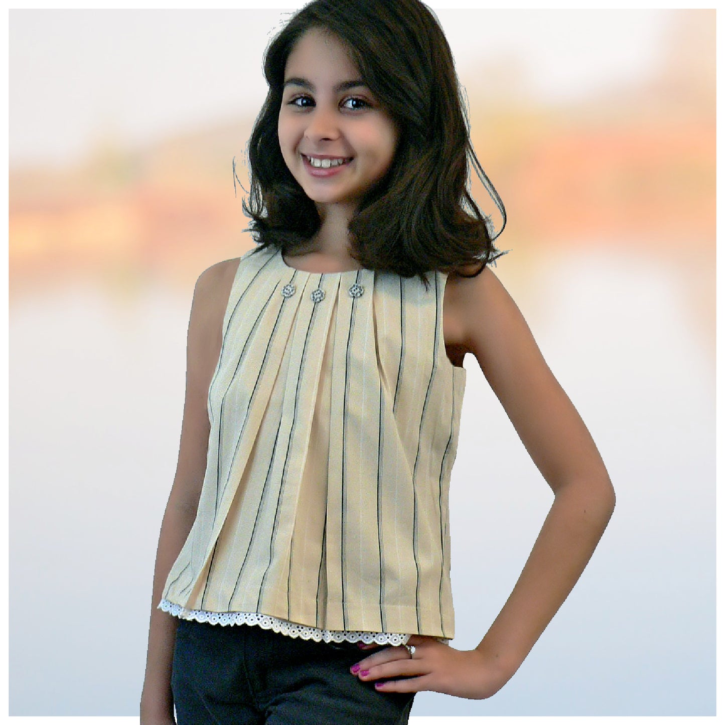 Pretty sleeveless summer dress with front pleats which open out. A-line shape, knee length. Sewing pattern and free video tutorial by Frocks & Frolics.