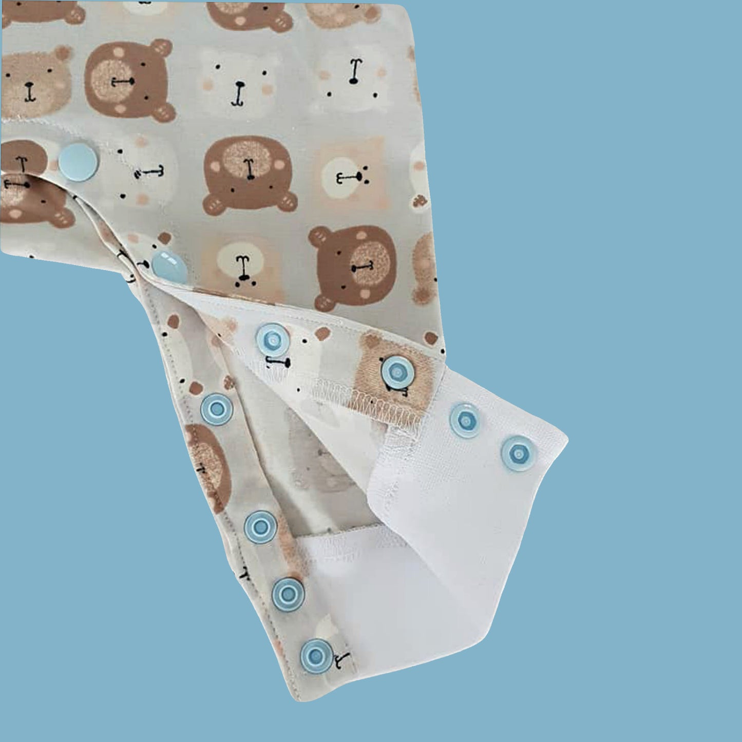 Lollipop romper, pdf sewing pattern by frocks and frolics. Raglan sleeves and full length legs with cuffs. Gusset in the inner leg seam and KamSnap closure.Teddybear print. Comes with video tutorial.