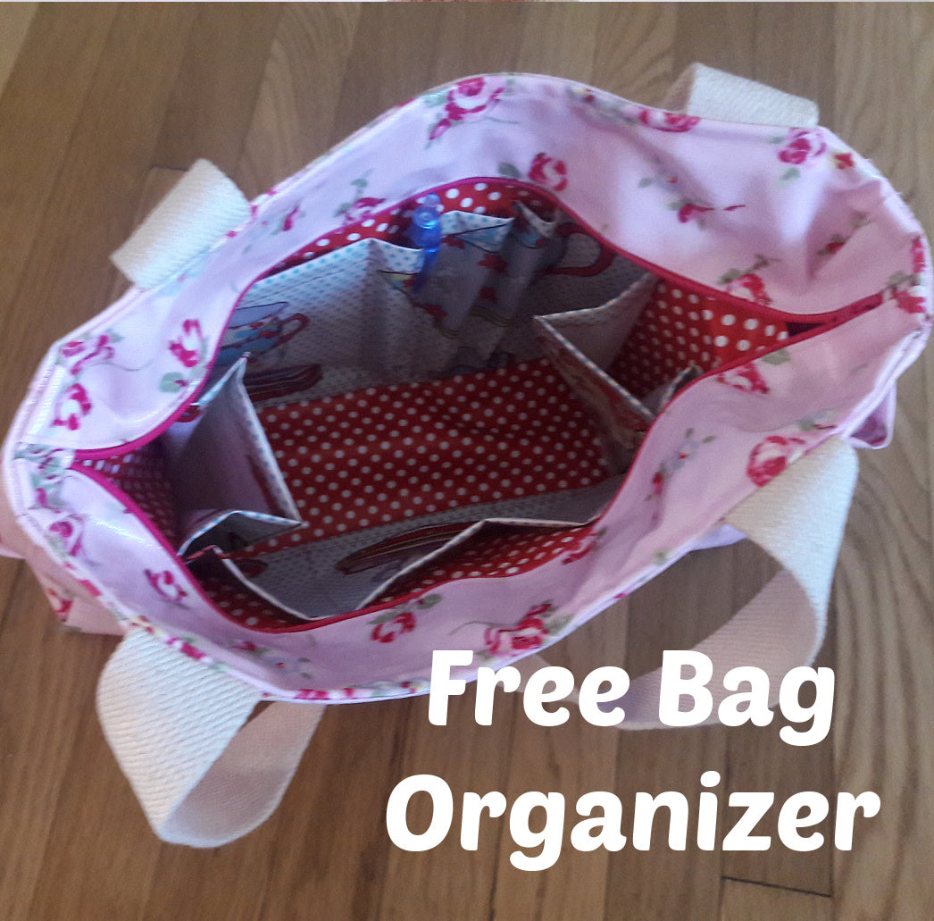 London tote bag pdf sewing pattern by Frocks & Frolics. In laminated oil cloth. Pink with dianty flowers. Wide handles and outside pockets. Fully lined, recessed zip. Comes with a free video course.