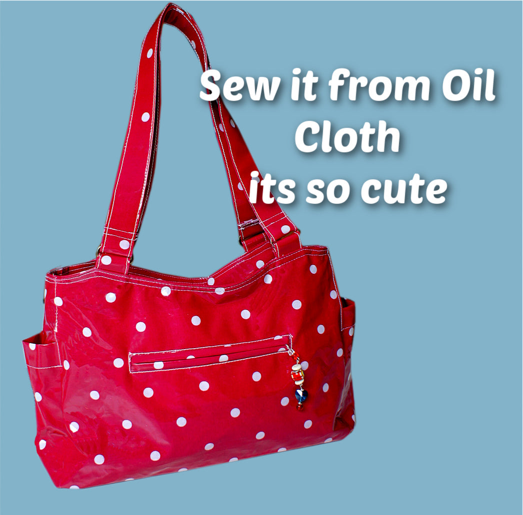 London tote bag pdf sewing pattern by Frocks & Frolics. In laminated oil cloth. Pink with dianty flowers. Wide handles and outside pockets. Fully lined, recessed zip. Comes with a free video course.