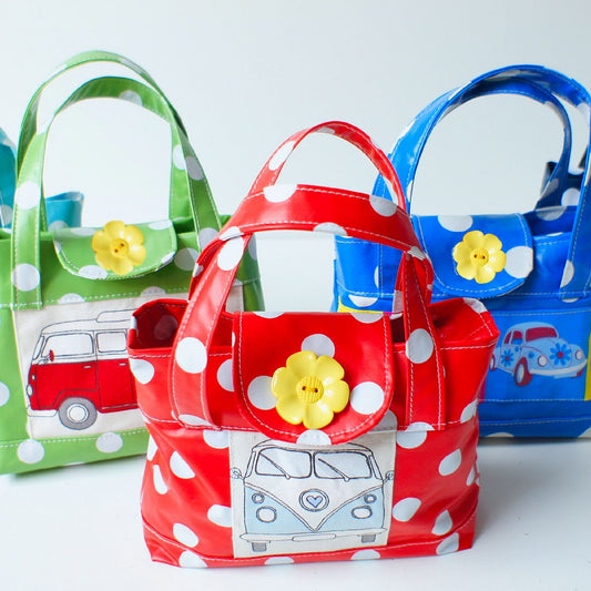 Mary-Lou girls tote, pdf sewing pattern by frocks and frolics. Made in both upholstery fabric and laminated table cloth or oil fabric. Fully lined with optional recessed zip. Comes with many video tutorials for multiple sewing methods.