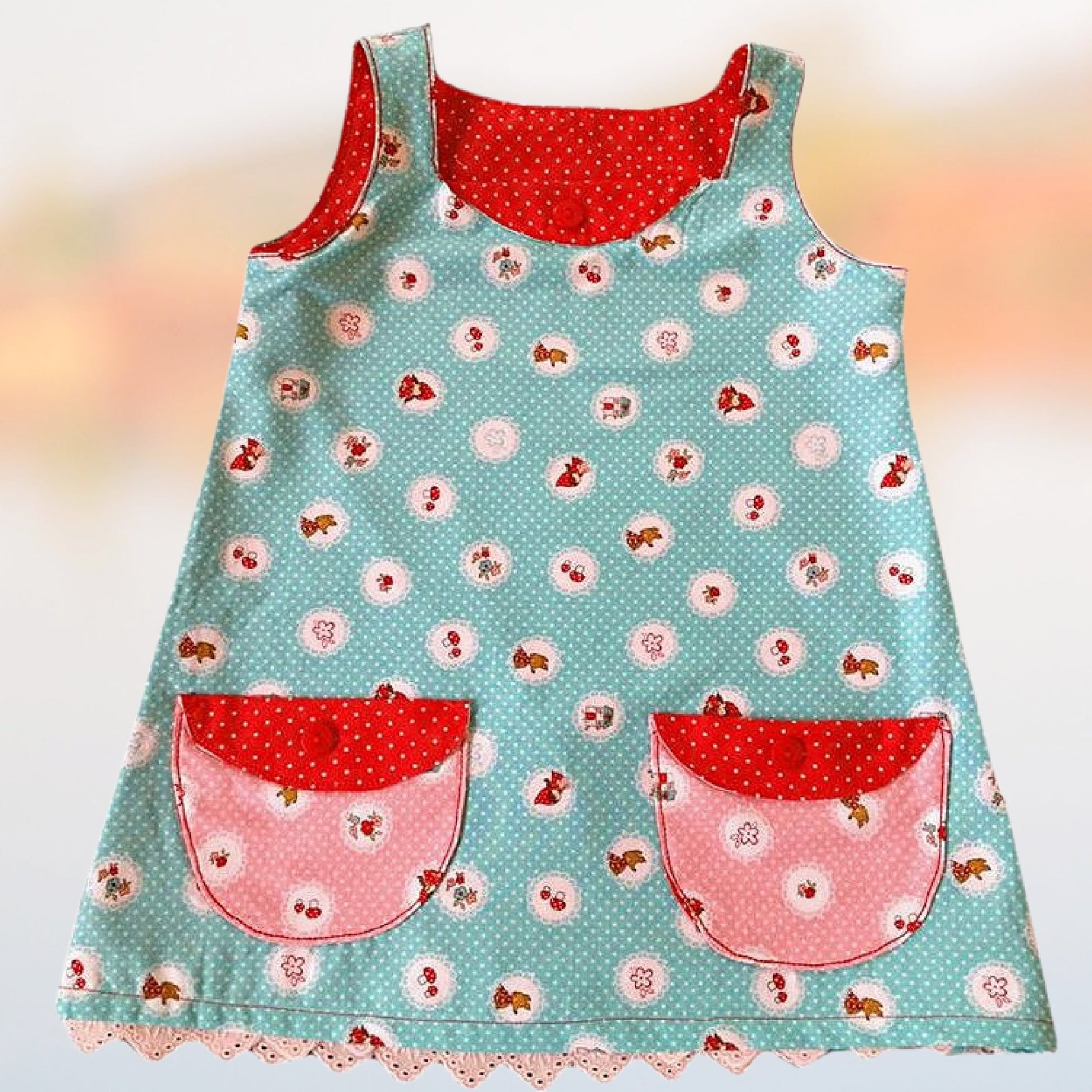 Megan dress pdf sewing pattern with Video tutorial. It's an A line shape, with no closure and a fold over front embellishment. It's fully lined and suitable for beginners. Easy project with cute patch pockets.