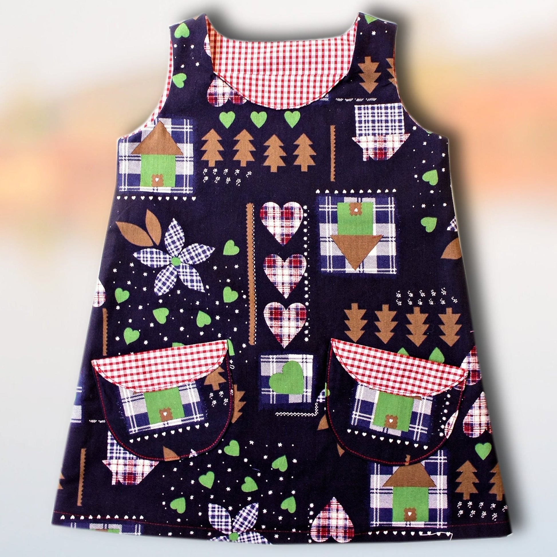 Megan dress pdf sewing pattern with Video tutorial. It's an A line shape, with no closure and a fold over front embellishment. It's fully lined and suitable for beginners. Easy project with cute patch pockets.