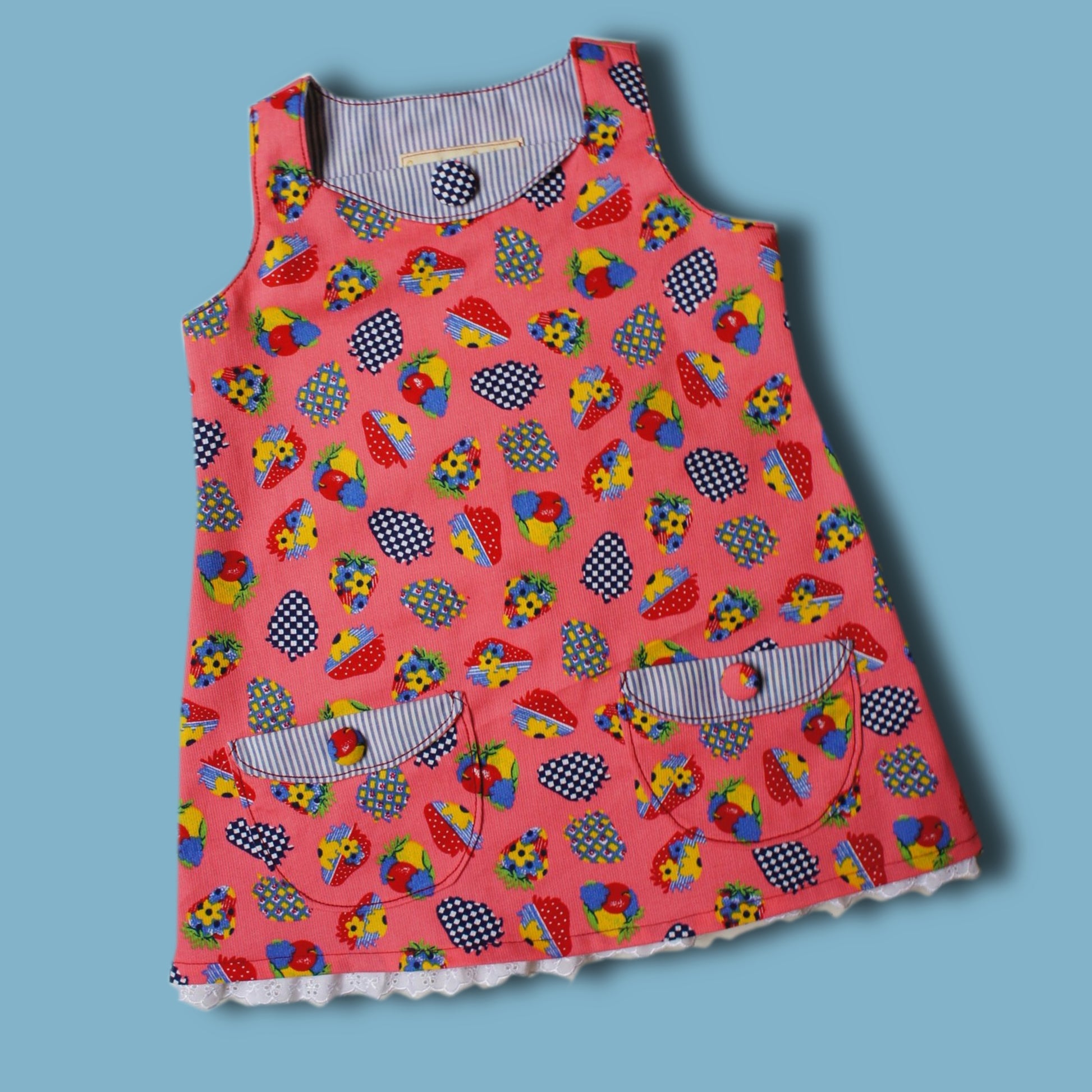 Megan dress pdf sewing pattern with Video tutorial. It's an A line shape, with no closure and a fold over front embellishment. It's fully lined and suitable for beginners. Easy project with cute patch pockets.