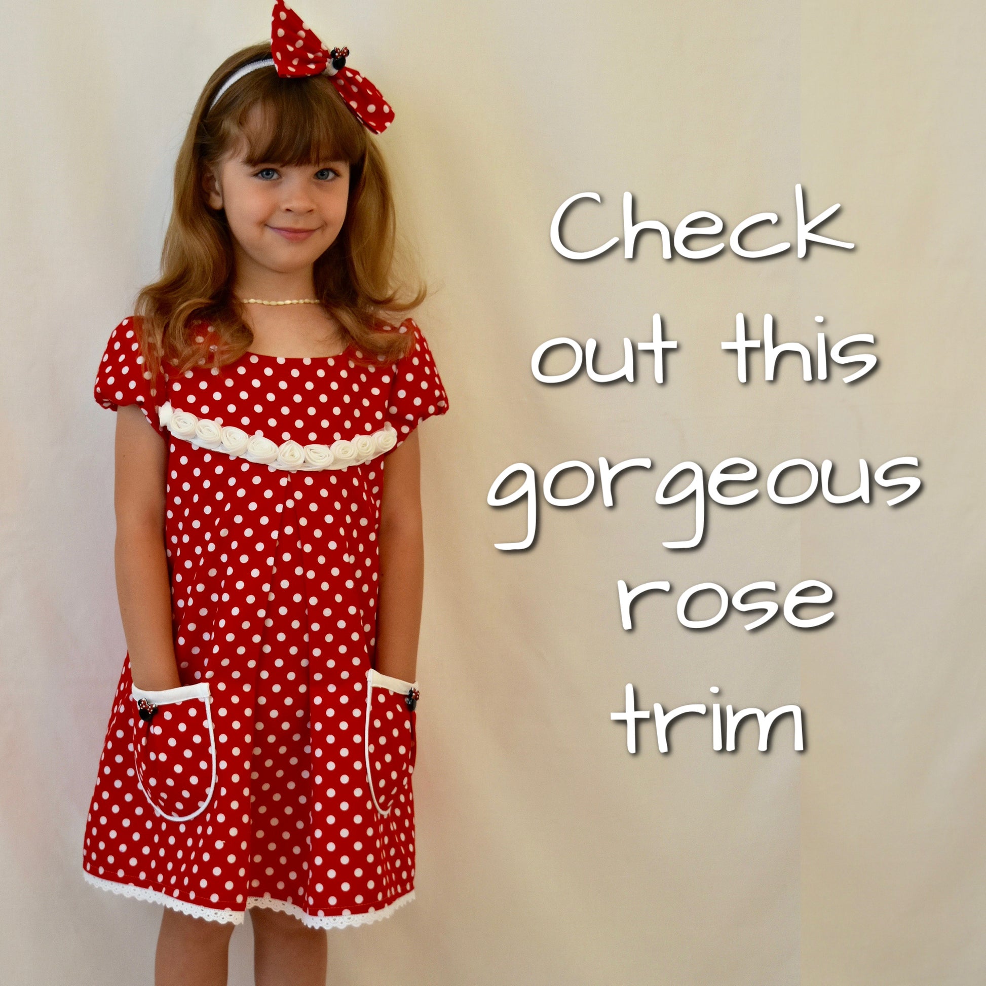 Millie dress pdf sewing pattern by Frocks & Frolics. Empire line bodice and slightly gathered skirt. Puff sleeves with elastication. Patch pockets with piping. Bodice has a cute lace trim. The fabric is white polka dots on a red cotton.