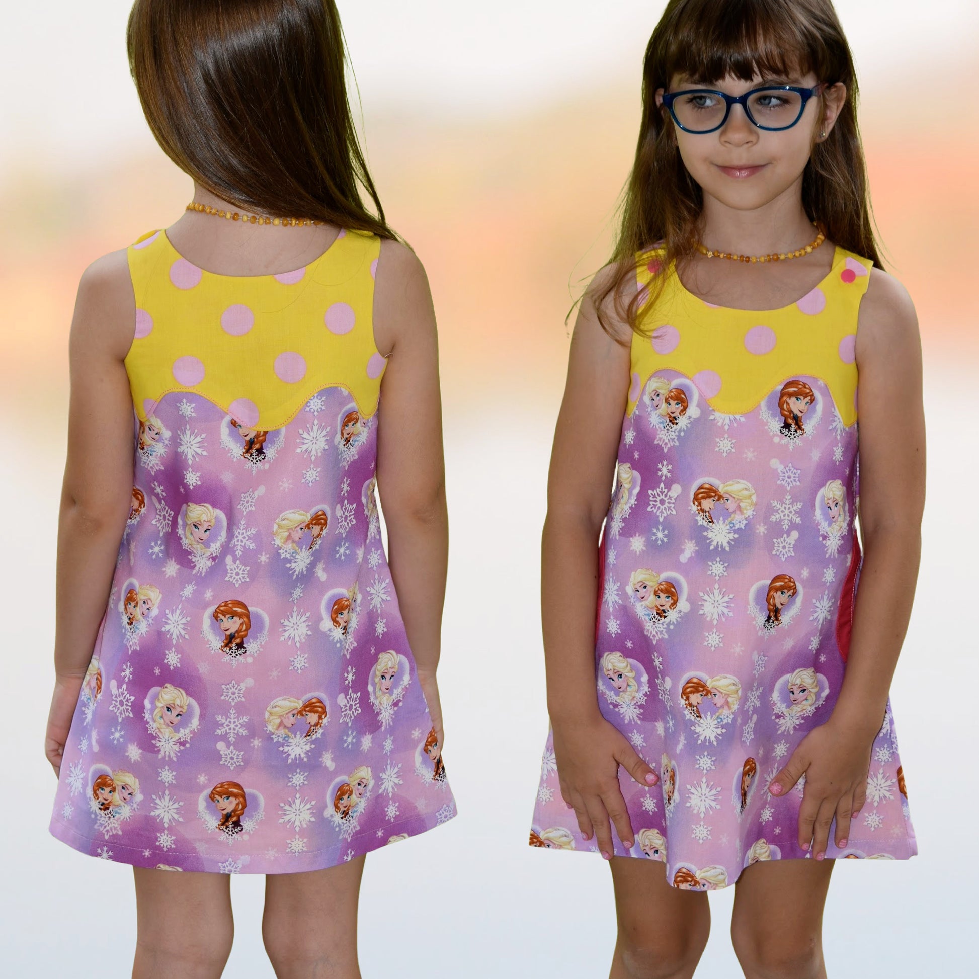 Mimi apron dress pdf sewing pattern. For girls age 1-12. Fully lined with side pockets and cute applique. In white polka dots with mint back base. Colour blocking with a flower print. Front and back view.