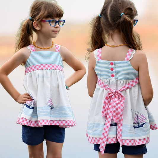 Natalie girls pinafore dress, pdf sewing pattern by Frocks & Frolics. High waist and sash with ties.  Here featuring a combination of Michael Miller fabrics in Gingham and sea side themed fabrics. Double layer hem completes the look.