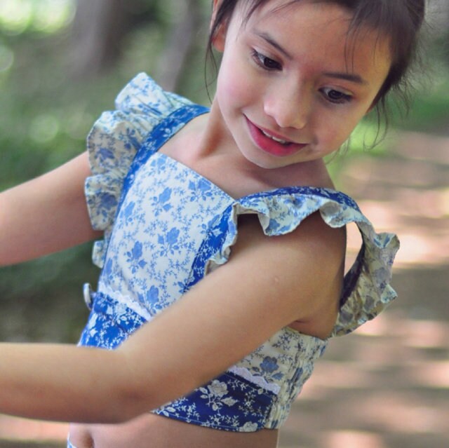 Tilly crop top, pdf sewing pattern by Frocks & Frolics. Cute girls blouse with flutter sleeves and vintage inspired.Sewn in a cotton print in cream and blue.