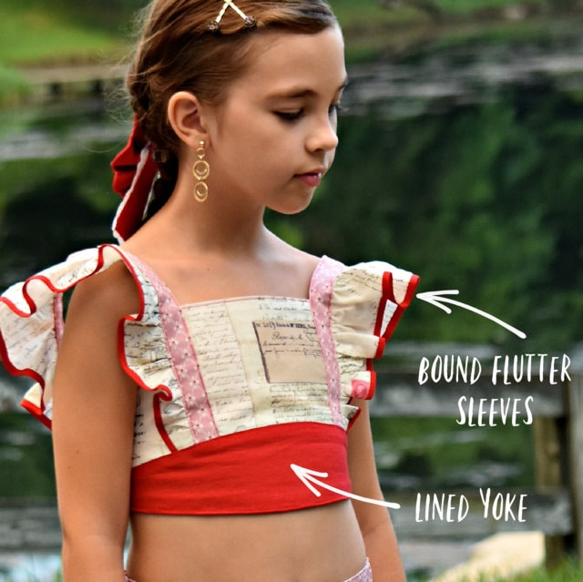 Tilly crop top, pdf sewing pattern by Frocks & Frolics. Cute girls blouse with flutter sleeves and vintage inspired. Made in gorgeous Michael Miller fabrics in cotton and red linen. Bound flutter sleeves and a lined yoke.