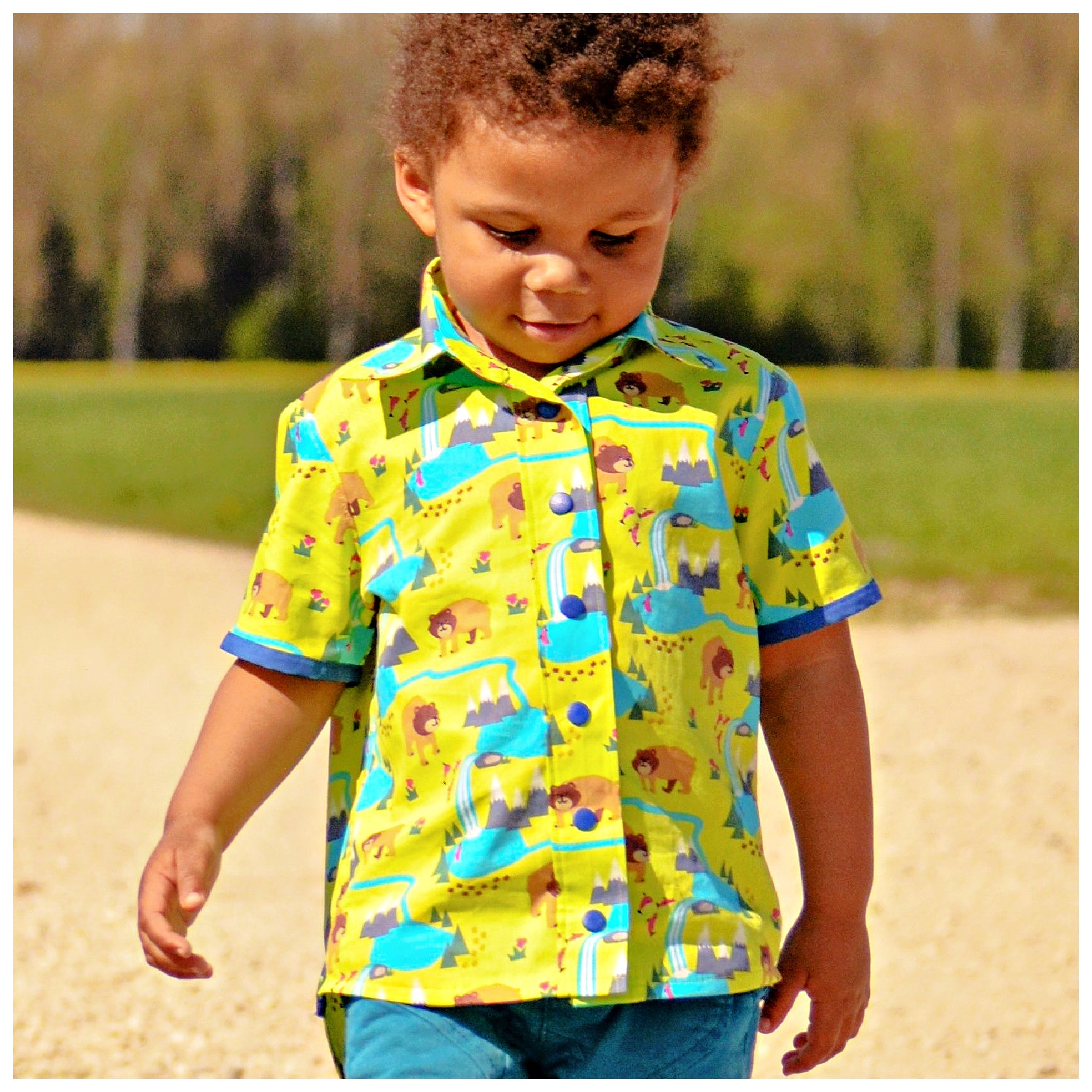 Cool shirt, pdf sewing pattern for a button down shirt by Frocks & Frolics.  The shirt has animal prints and a blue trim. High low hem feature. Includes a video sewing course explaining every step in detail. Back view.