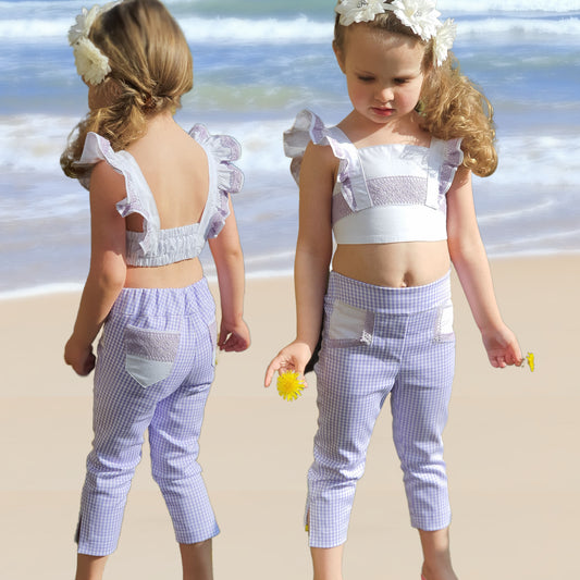 Audrey Capri pants pdf sewing pattern. In classic Gingham with vintage pockets and slim cut legs. Classic side vents at the hem. This pattern comes with a video sewing course.