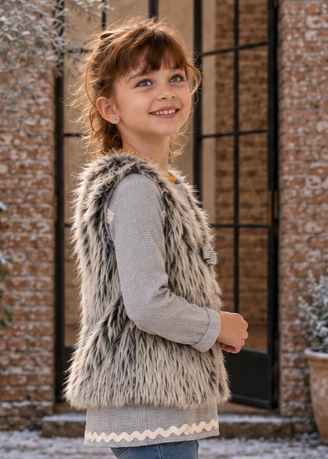 Baby Vest sewing pattern – smiling girl in shaggy faux fur kids vest, side view close-up