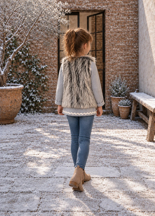 Baby Vest sewing pattern – girl in grey shaggy faux fur reversible vest, back view
