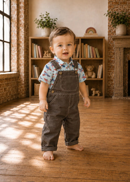 Bobby Dazzler Dungarees sewing pattern – toddler in brown dungarees with a printed shirt, front view
