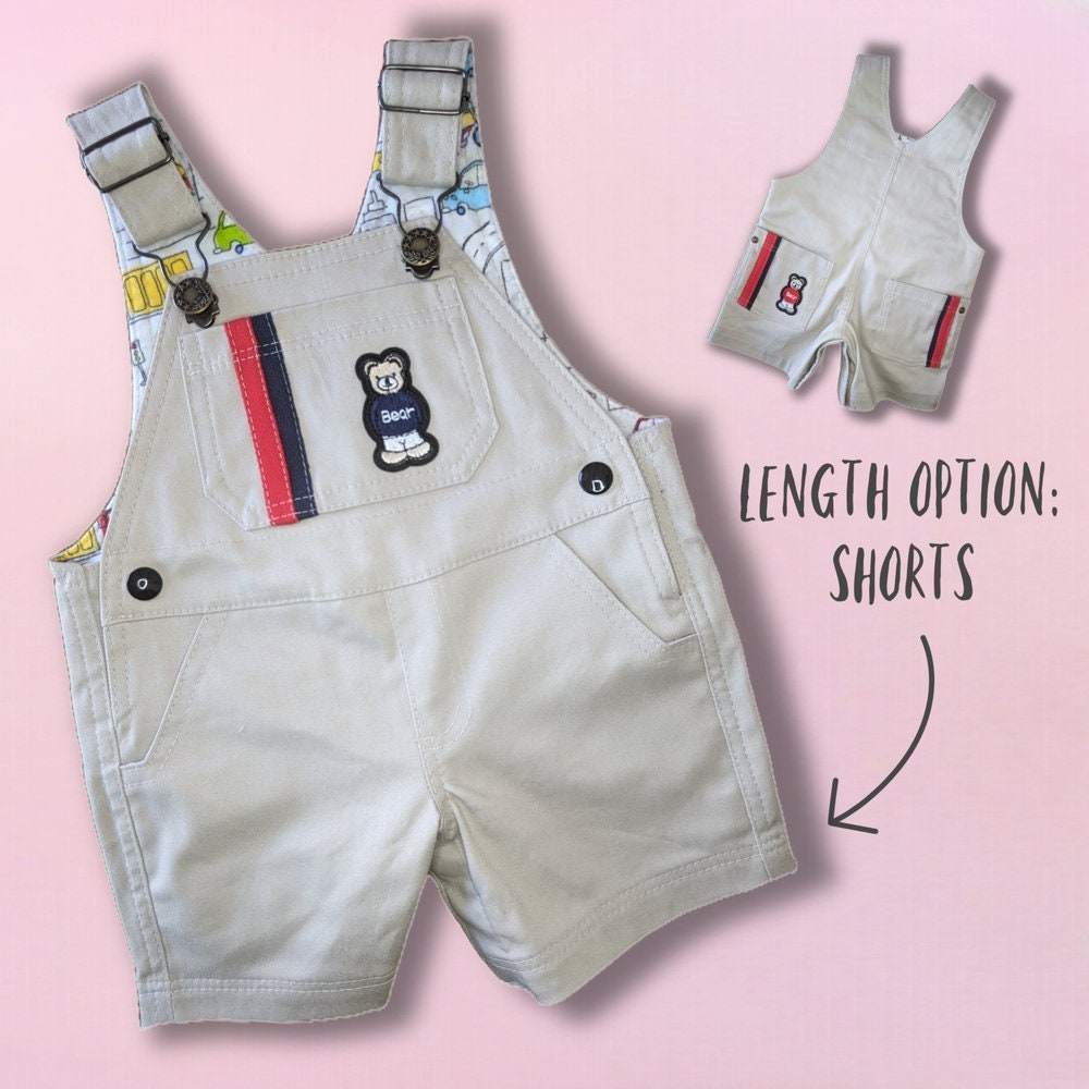 Bobby Dazzler overalls pdf sewing pattern. Short version. Classic dungaree pattern by Frocks and Frolics. Features leg opening for nappy changes, western pockets, a bib, snaps and metal jeans buttons. Sewing pattern includes a video course.