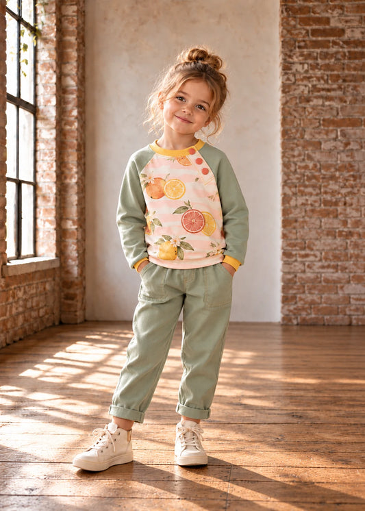 Bubble Gum Joggers & Jelly Bean Sweater patterns – girl in citrus print raglan and sage joggers, front view