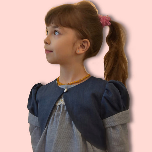 Bolero jacket, pdf sewing pattern by frocks and frolics. With puff sleeves or elasticated sleeves or pretty bias binding. Fully lined. In blue linen with Gingham lining and sleeve cuffs.