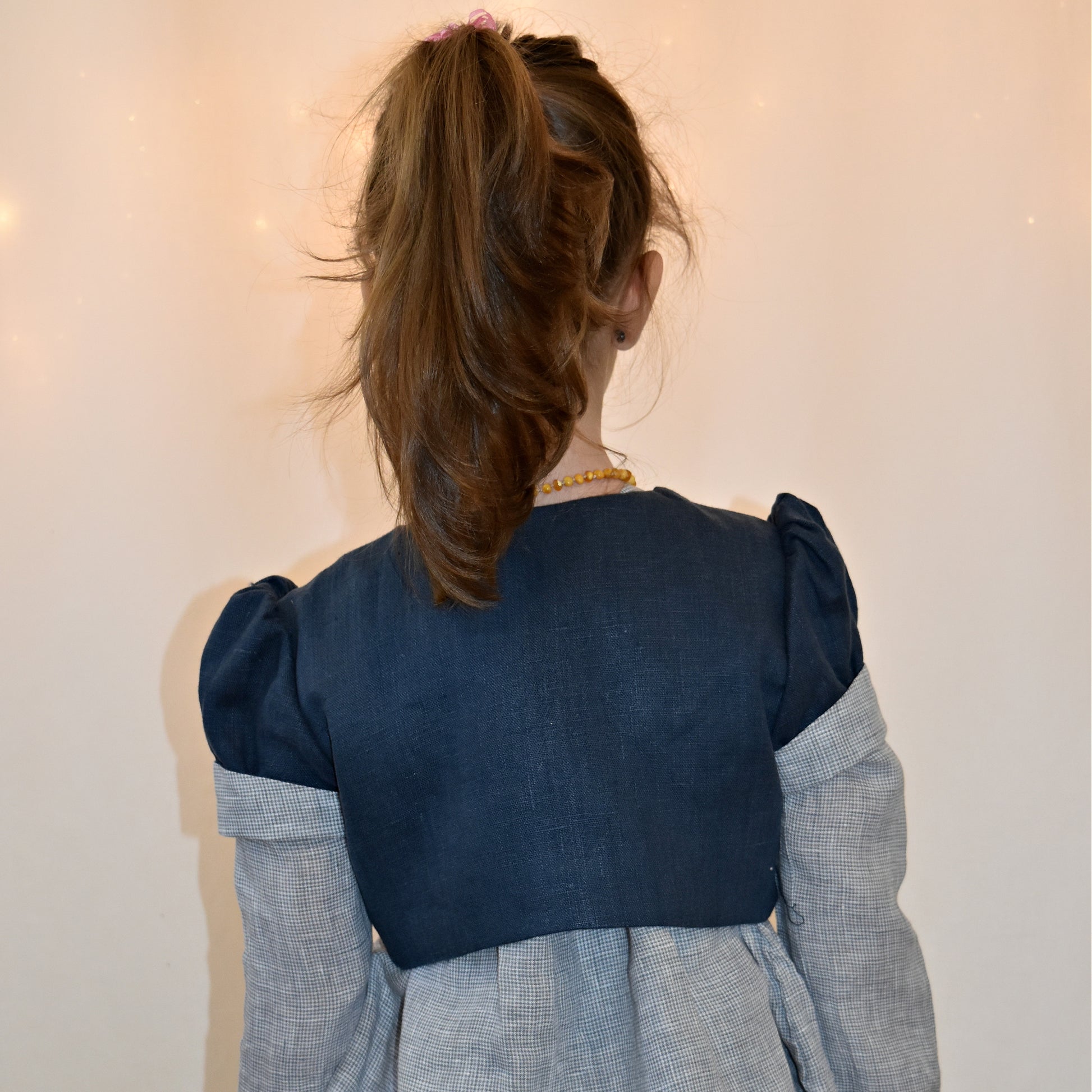 Bolero jacket, pdf sewing pattern by frocks and frolics. With puff sleeves or elasticated sleeves or pretty bias binding. Fully lined. In blue linen with Gingham lining and sleeve cuffs.