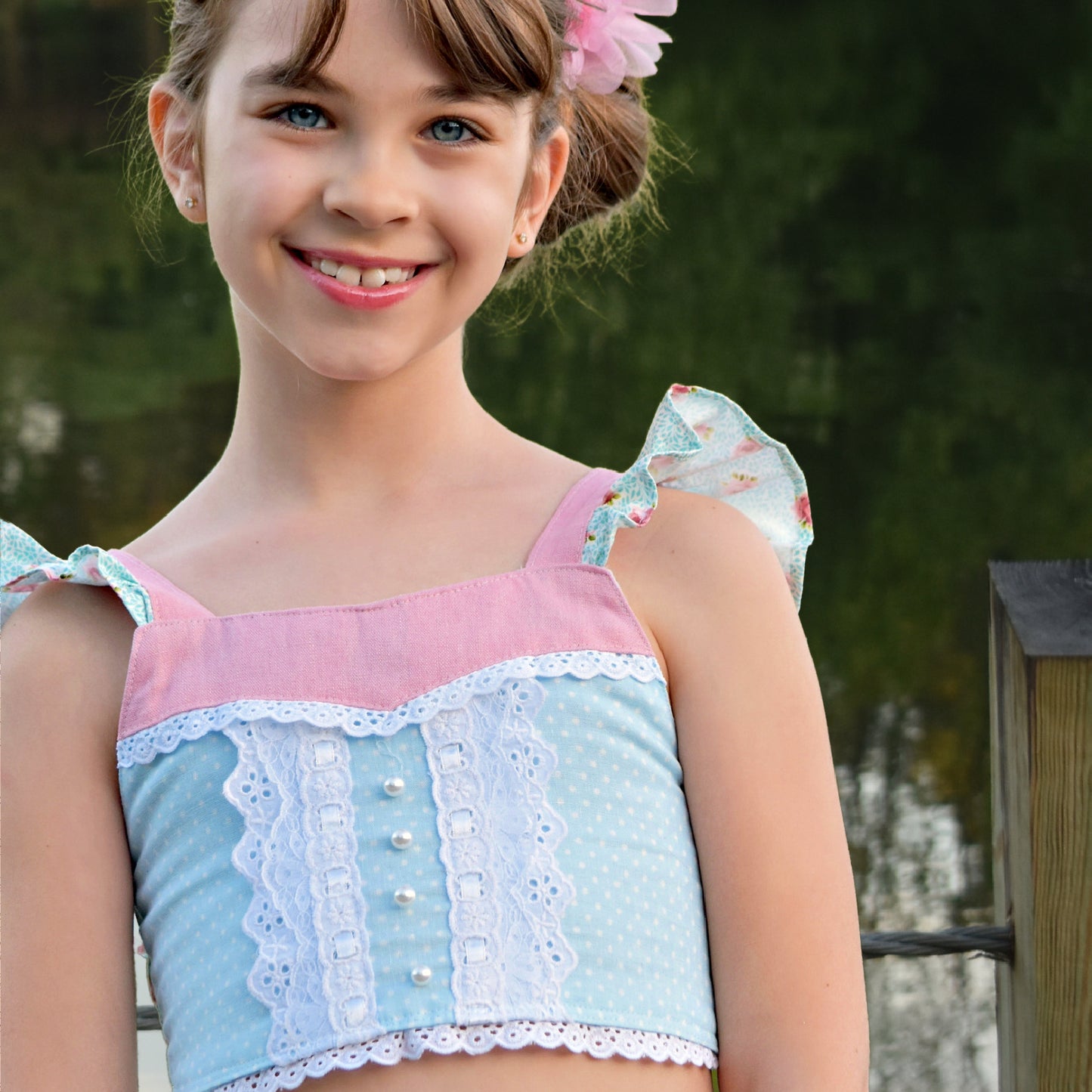 Connie blouse, pdf sewing pattern by Frocks & Frolics. Featuring a decorative yoke in pink linen with lace edging. Cute flutter sleeves in pastel blue and pink print by Michael Miller. Vintage collection poster
