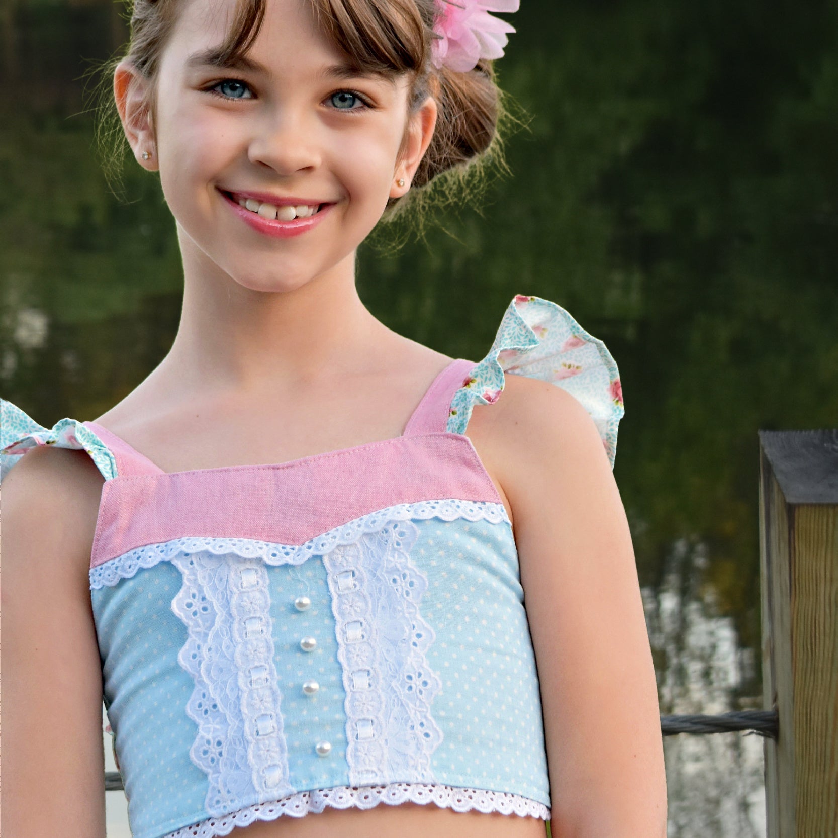 Connie blouse, pdf sewing pattern by Frocks & Frolics. Featuring a decorative yoke in pink linen with lace edging. Cute flutter sleeves in pastel blue and pink print by Michael Miller. Vintage collection poster
