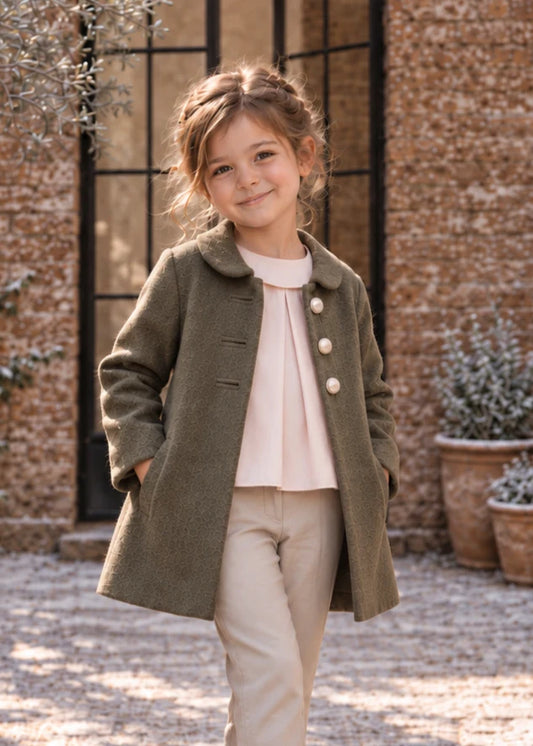 Dakota Pea Coat sewing pattern – girl in olive green wool coat with round collar and cream buttons, front view