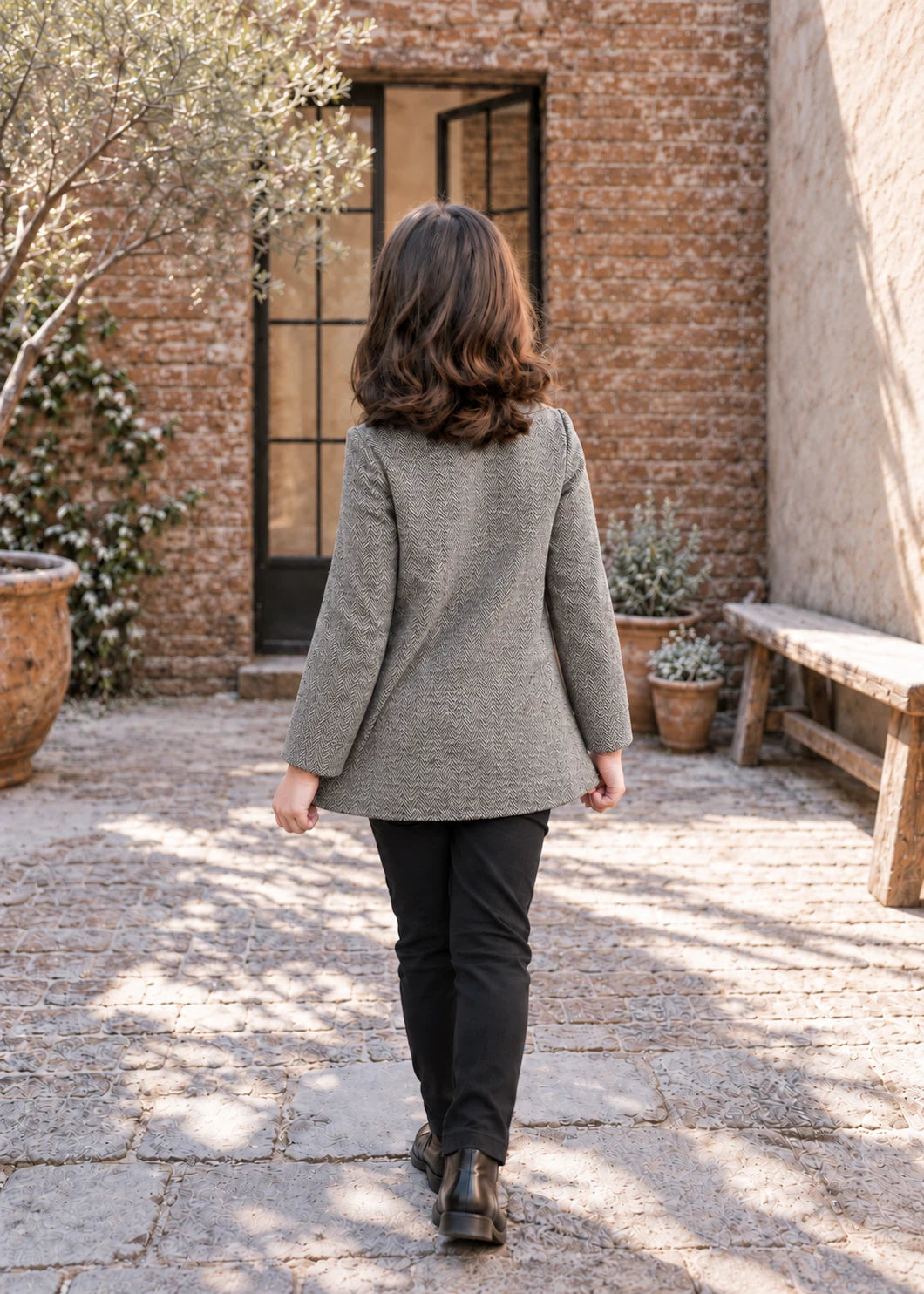 Dakota Pea Coat sewing pattern – short grey wool coat with flared A-line back, girl walking away