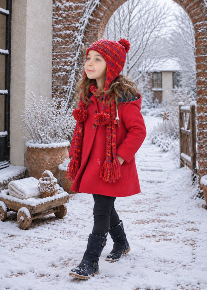 Dakota Pea Coat sewing pattern – red pea coat with knitted hat and scarf, girl walking in a snowy garden