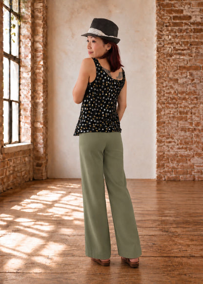 Devon Pants sewing pattern – back view of sage green straight-leg pants showing the back darts, with a black floral top